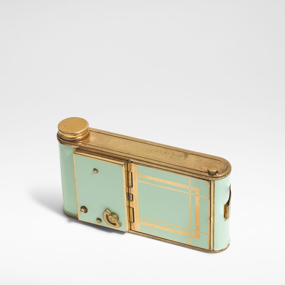 Swiss Art Deco nécessaires, circa 1935: Swiss Art Deco nécessaires, circa 1935 Enamel on gilt metal, comprising; a powder compact, a lipstick, a cigarette compartment, and a wind up music box. 6 cm high, 10.5 cm wide, 2.5 cm