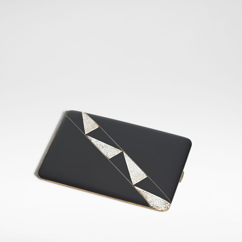 In the manner of Jean Dunand Art Deco cigarette case, circa 1930: In the manner of Jean Dunand Art Deco cigarette case, circa 1930 Coquille d'œuf lacquer on gilt metal, internally gilt, the verso with monogram HLY. 9 cm high, 12.5 cm wide, 1 cm