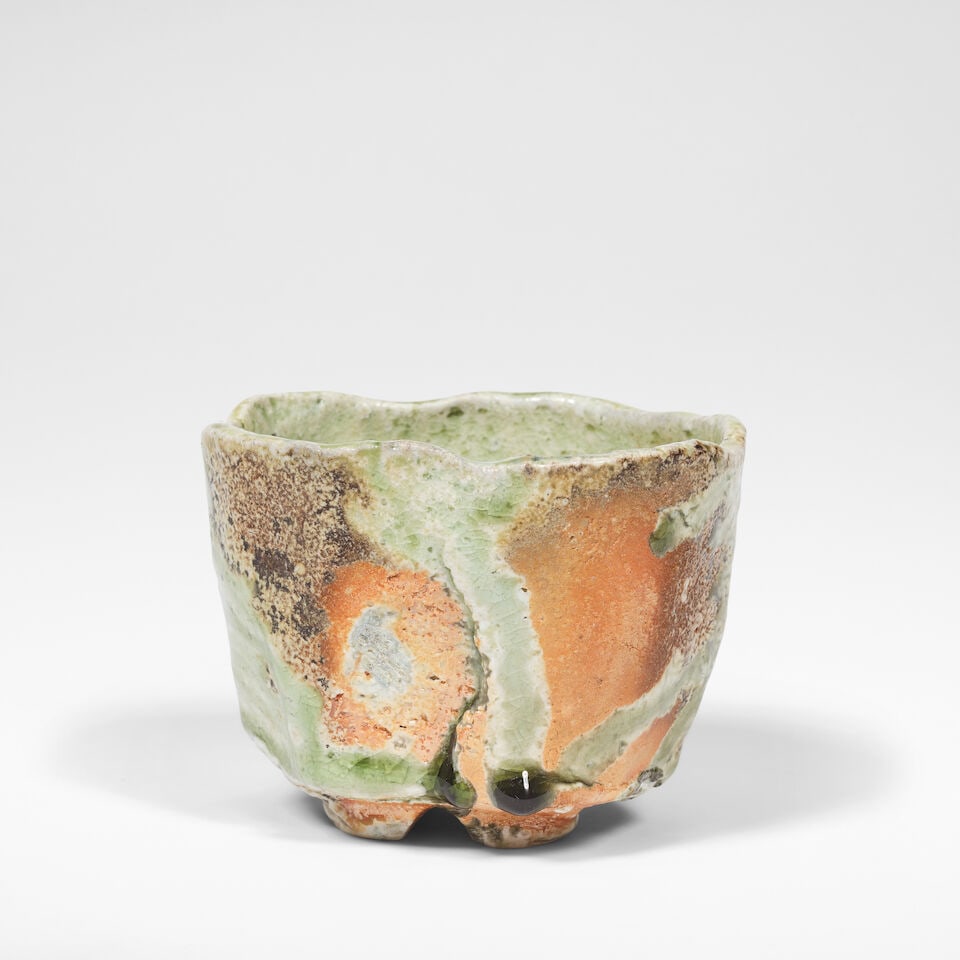 Fujioka Shuhei Tea bowl, late 20th Century: Fujioka Shuhei Tea bowl, late 20th Century Stoneware, running ash green glaze over a brown body with subtle shimmer, the foot with an incised cross. 10 cm high, 12.5 cm wide, 12 cm deep Together with