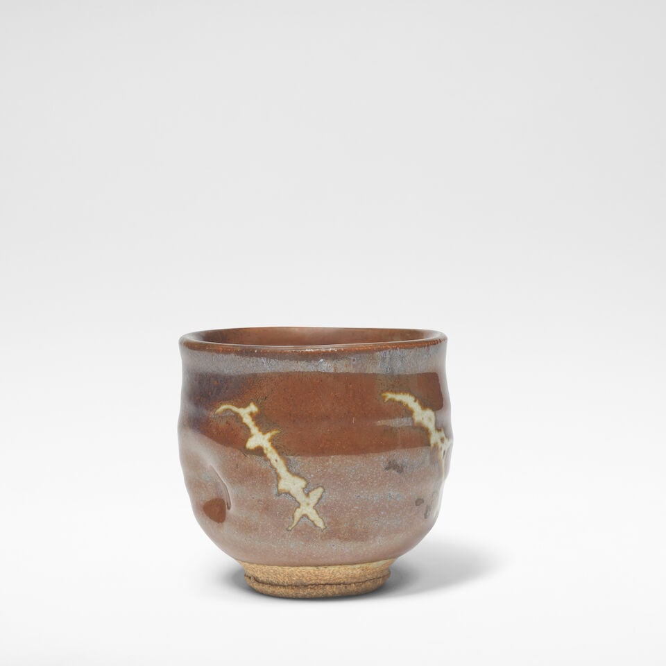 Shoji Hamada Tea bowl: Shoji Hamada Tea bowl Stoneware, persimmon and pale grey glazes with wax resist stem motif and impressed thumb mark. 8 cm high, 8.5 cm diameter Together with two books, Shoji Hamada: A Potter's Way &