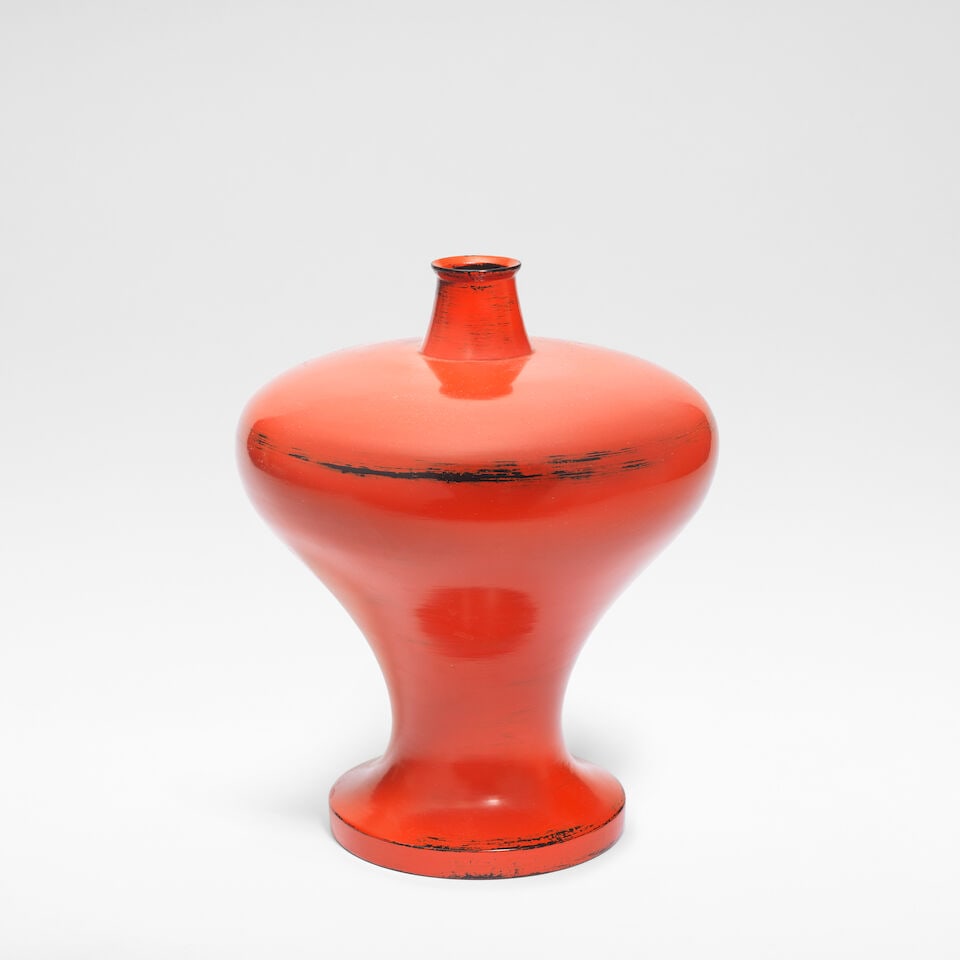 Murase Jihei III Bottle vase: Murase Jihei III Bottle vase Wood, red Negoro lacquer, revealing black streaks to foot, shoulder and rim. 10.5 cm high, 22.2 cm wide, 21.5 cm deep Underside with artist's lacquered signature.