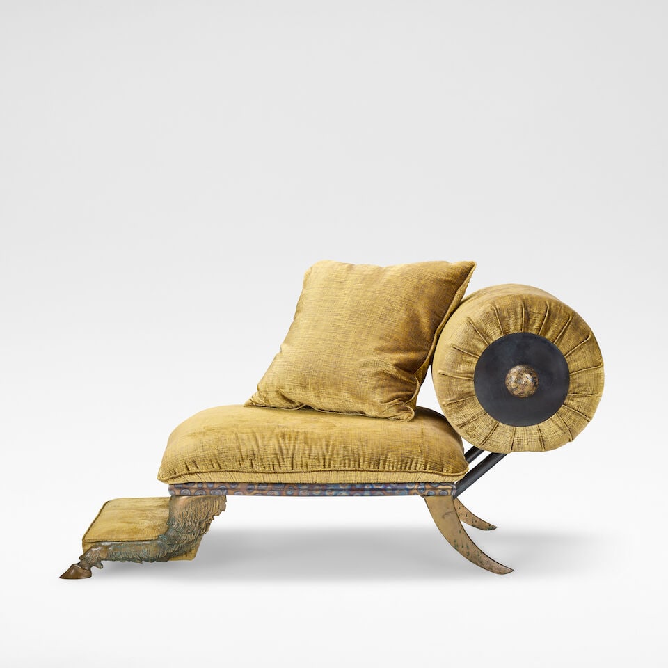 Mark Brazier-Jones 'Pan' chair, designed 1992, executed 1993: Mark Brazier-Jones 'Pan' chair, designed 1992, executed 1993 Patinated bronze, fabric upholstery, raised to the front on goat's hooves, to the verso on sabre supports. 77 cm high, 150 cm wide, 77 cm d