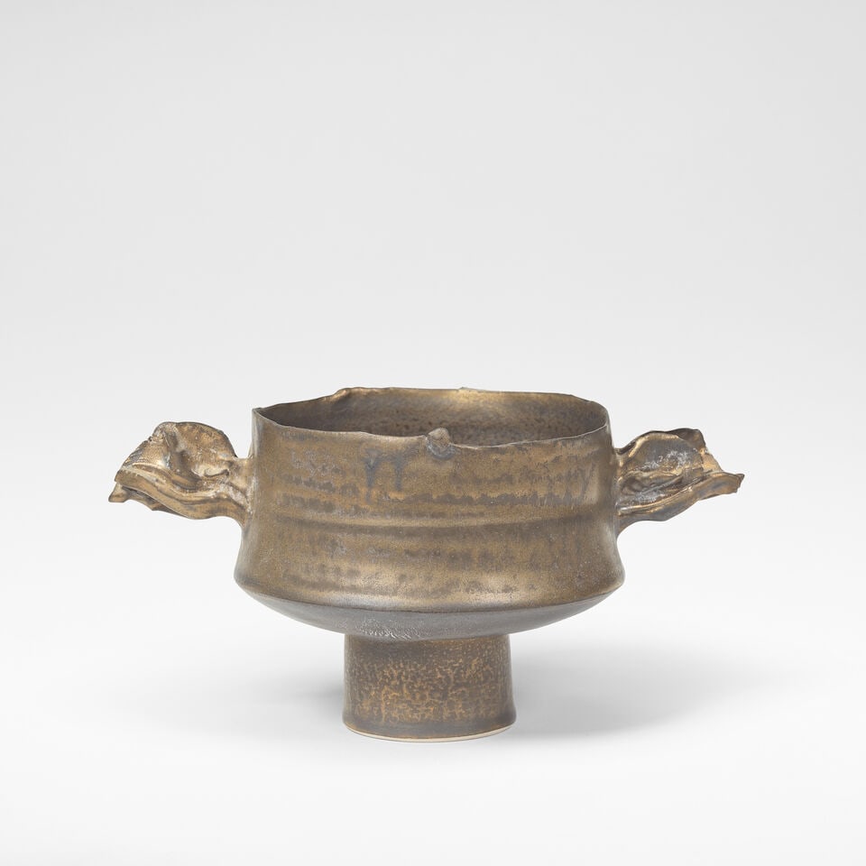 Colin Pearson Small stem bowl with wings: Colin Pearson Small stem bowl with wings Porcelain, golden bronze glaze, mounted with two double combed wings. 9 cm high, 18 cm wide, 11 cm deep Underside impressed with artist's seal. This lot is