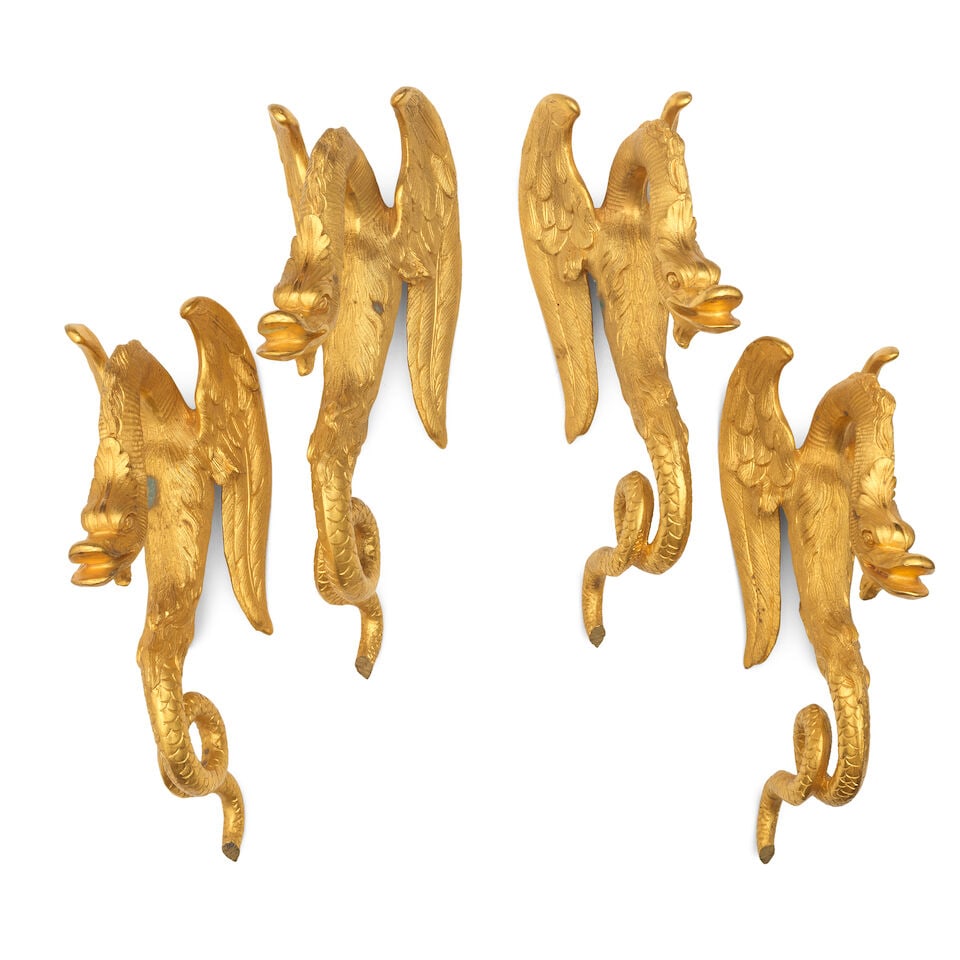 A set of four gilt bronze serpent vase mounts or handles: A set of four gilt bronze serpent vase mounts or handles The winged beasts with undulating scaly tails, 24cm high, 9cm wide, 14cm deep For further information on this lot please visit Bonhams.com For