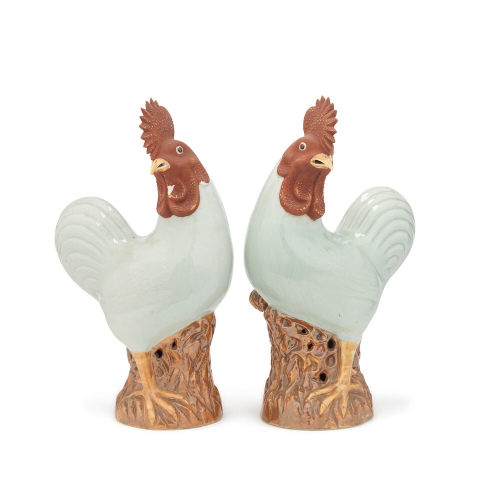 A pair of Chinese porcelain models of cockerels Late Qing Dynasty, probably late 19th century/ea...: A pair of Chinese porcelain models of cockerels Late Qing Dynasty, probably late 19th century/early 20th century The blanc de chine glazed bodies with matt red painted heads and crestings on naturalis