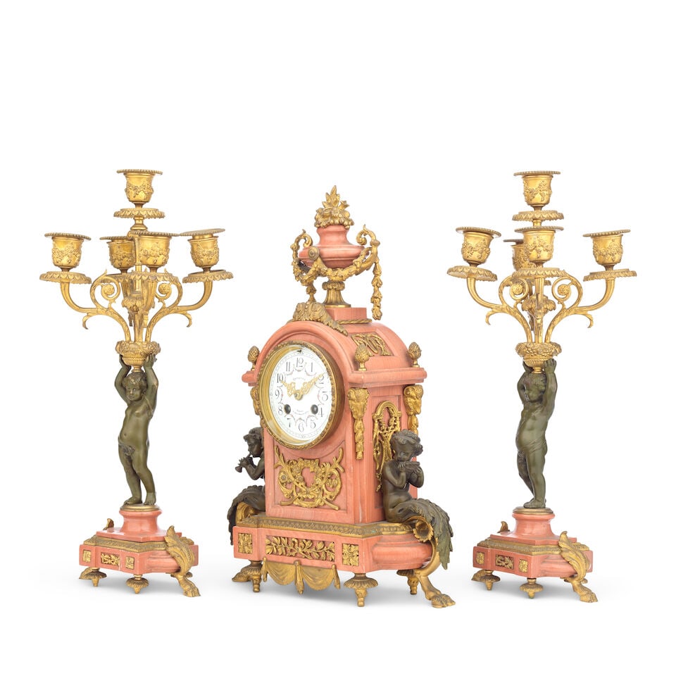 A late 19th/early 20th century French gilt and patinated bronze mounted pink marble figural cloc... - 2
