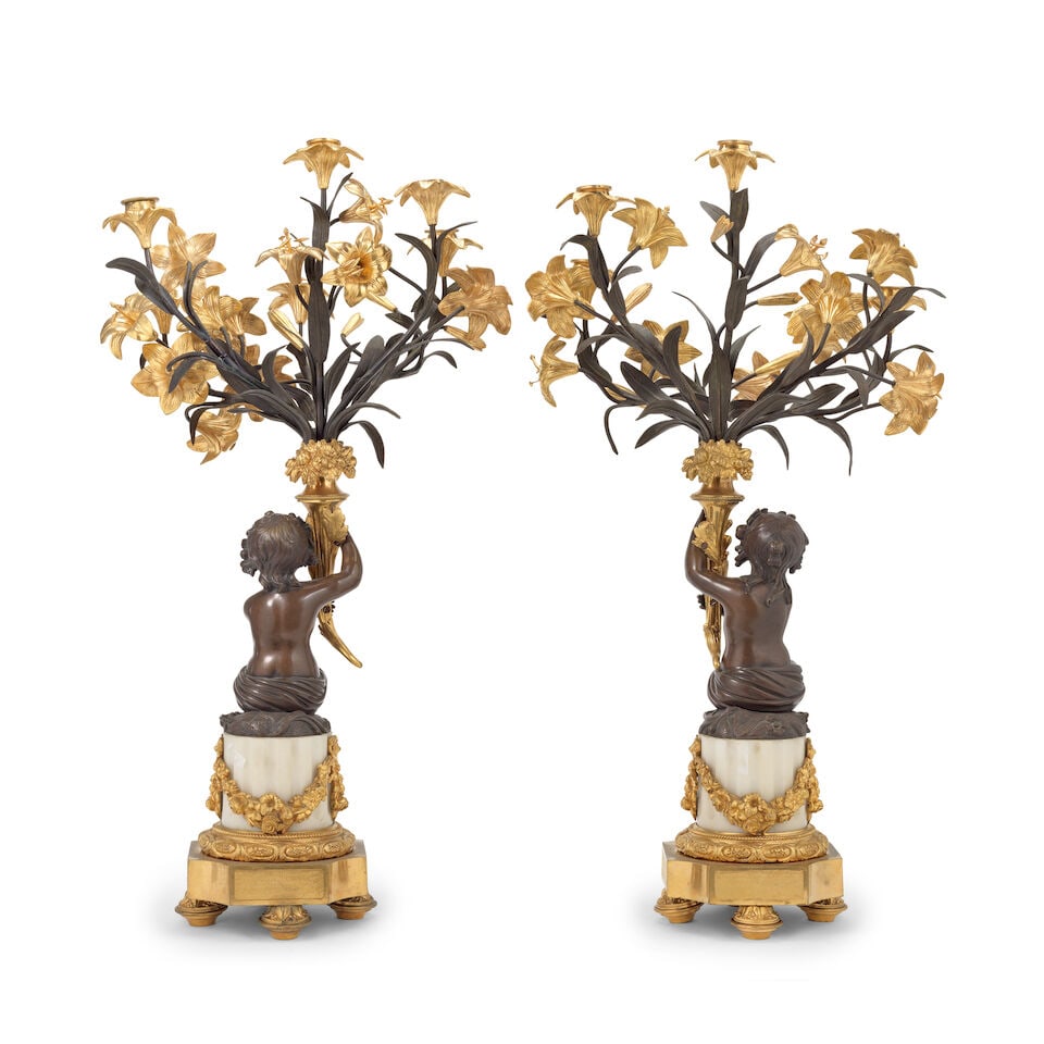 A pair of late 19th century French gilt and patinated bronze five-light figural garniture candel... (1 of 2)
