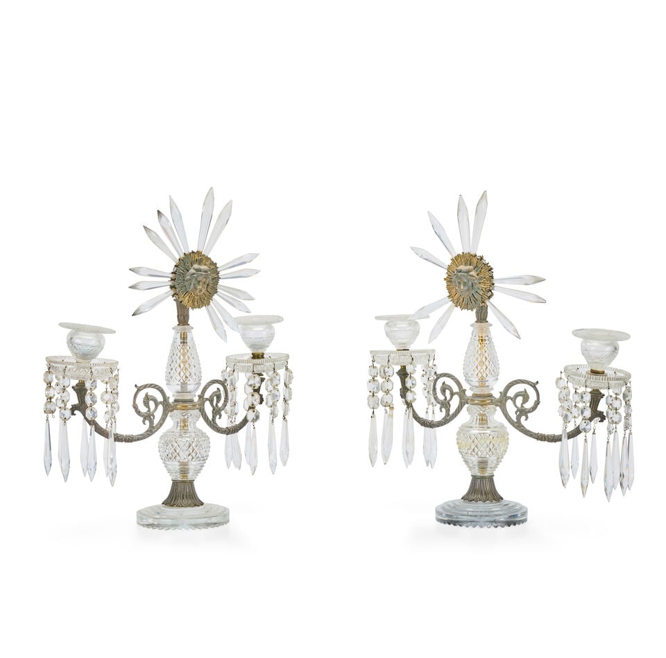 A pair of George IV gilt bronze mounted cut glass sunburst twin light lustre candelabra In the m...: A pair of George IV gilt bronze mounted cut glass sunburst twin light lustre candelabra In the manner of Apsley Pellatt The fruiting foliate scrolling arms supporting diamond cut banded urn shaped can