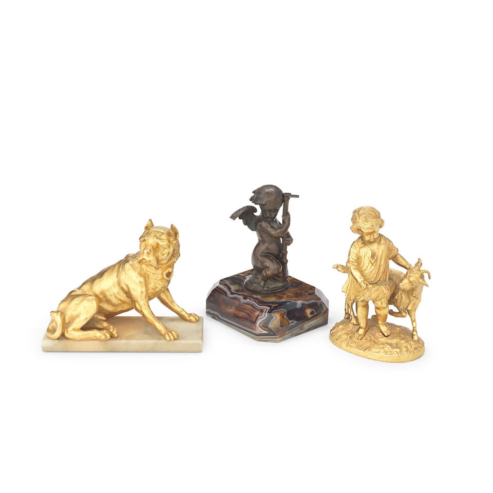 A gilt bronze model of a seated dog, together with a gilt bronze figural model of a young girl w...: A gilt bronze model of a seated dog, together with a gilt bronze figural model of a young girl with a goat and a patinated bronze model of a putto Probably late 19th/early 20th century The dog on rect