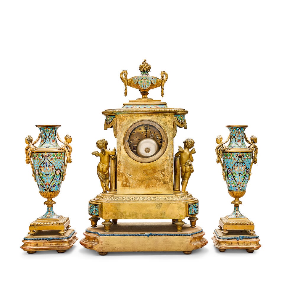 A good third quarter 19th century French gilt bronze and champlevé enamel clock garniture ... - 2
