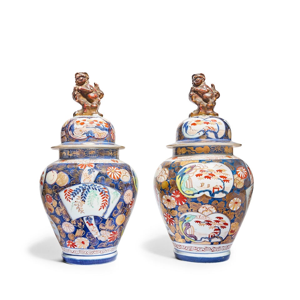 A pair of Japanese Imari decorated porcelain garniture vases and covers Late Meiji period (1868-...: A pair of Japanese Imari decorated porcelain garniture vases and covers Late Meiji period (1868-1912) or Taisho period (1912-1926) Each of inverted baluster form with narrow cylindrical necks, the dom