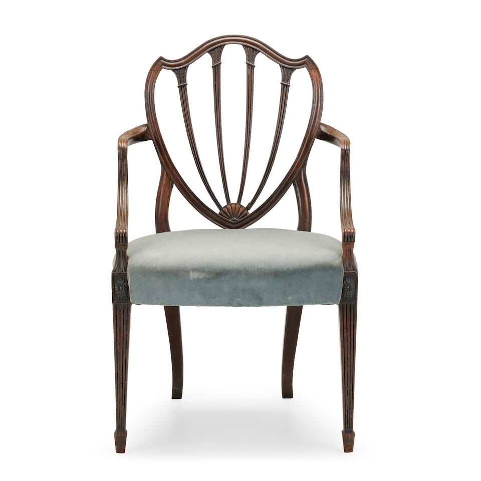 A George III mahogany open armchair of Gillows quality Circa 1785, possibly by Gillows: A George III mahogany open armchair of Gillows quality Circa 1785, possibly by Gillows With a pelta-shield shaped back and a stiff-leaf capped reeded tapering 'spindle' splat, with part-reeded downswe