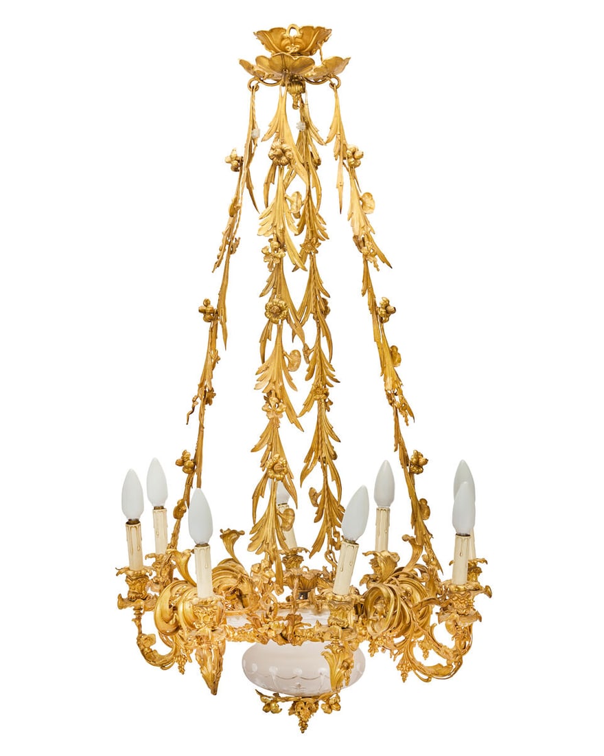 An impressive mid-19th French century gilt bronze eight-light chandelier: An impressive mid-19th French century gilt bronze eight-light chandelier The elaborate foliate, fruiting and floral cast acanthus scrolling candle arms with corresponding nozzles and drip pans issuing