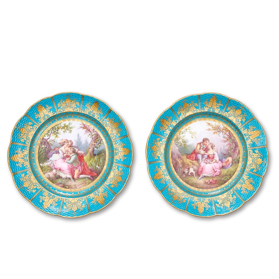 A pair of late 19th century French Sèvres-style porcelain plates (2): A pair of late 19th century French Sèvres-style porcelain plates Each painted with scenes of courting couples in wooded landscapes, with gilded ozier moulded edges on a bleu-céleste