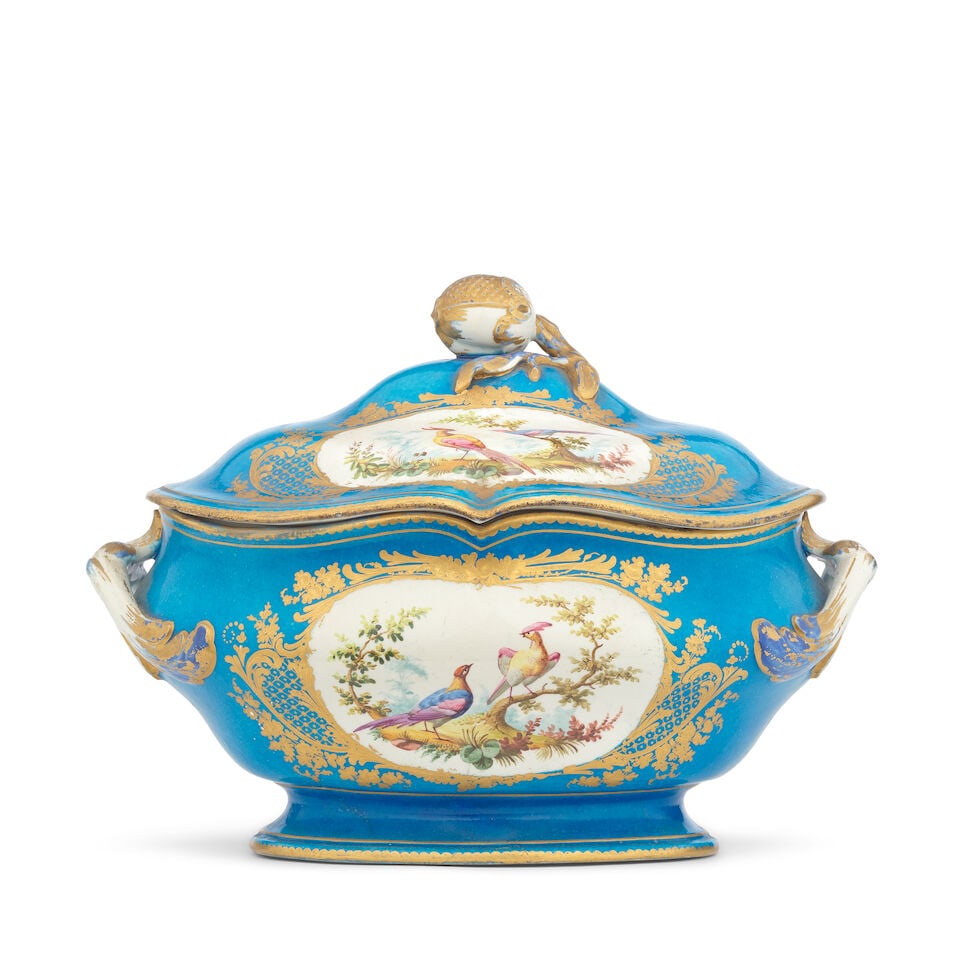 A late 19th century Sèvres-style porcelain oval tureen and cover: A late 19th century Sèvres-style porcelain oval tureen and cover Of oval form, the body with twin scrolling handles, the cover with fruiting finial, the whole painted with ovals of exotic birds a