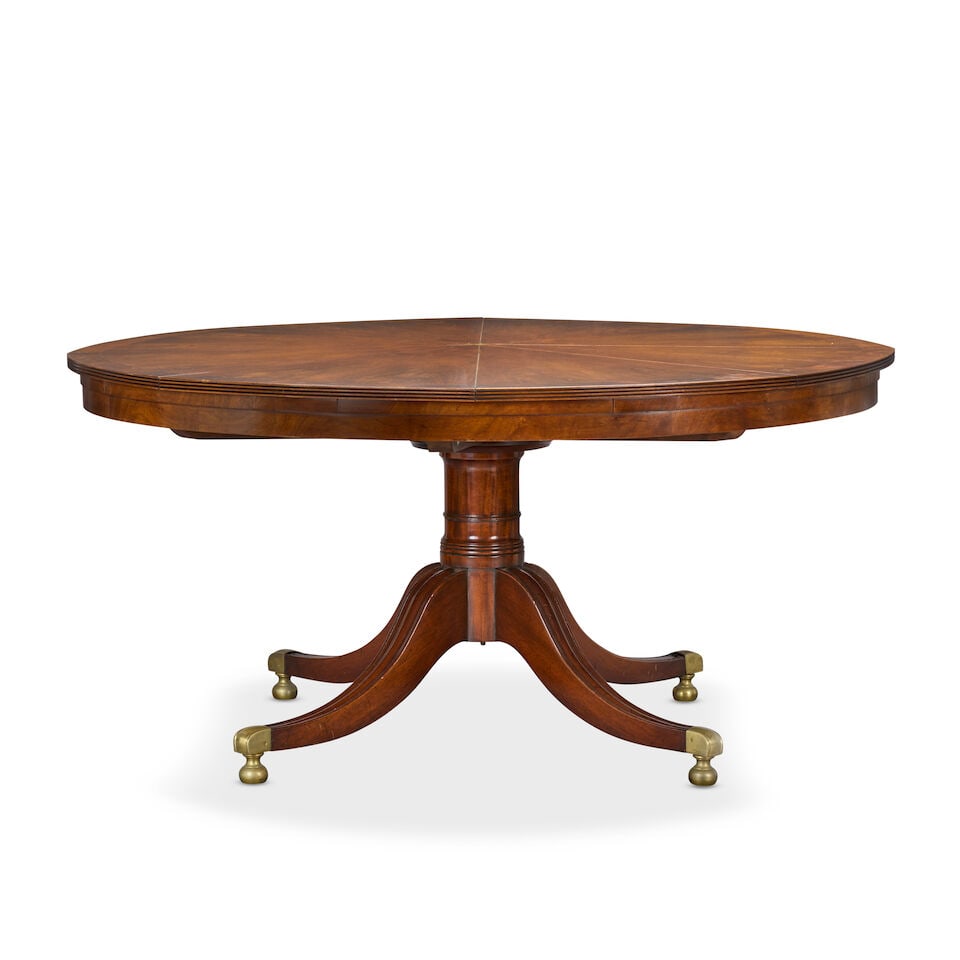 A mahogany 'Jupe' action extending circular dining table together with its leaf storage cabinet ... - 2