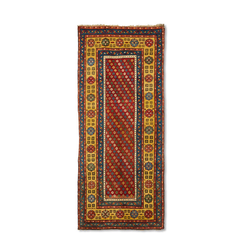 A Talish long rug South Caucasus, circa 1890 228cm x 101cm: A Talish long rug South Caucasus, circa 1890 The central madder field housing stars, enclosed by a gold border with stylised floral motifs, 228cm x 101cm This lot is subject to the following lot