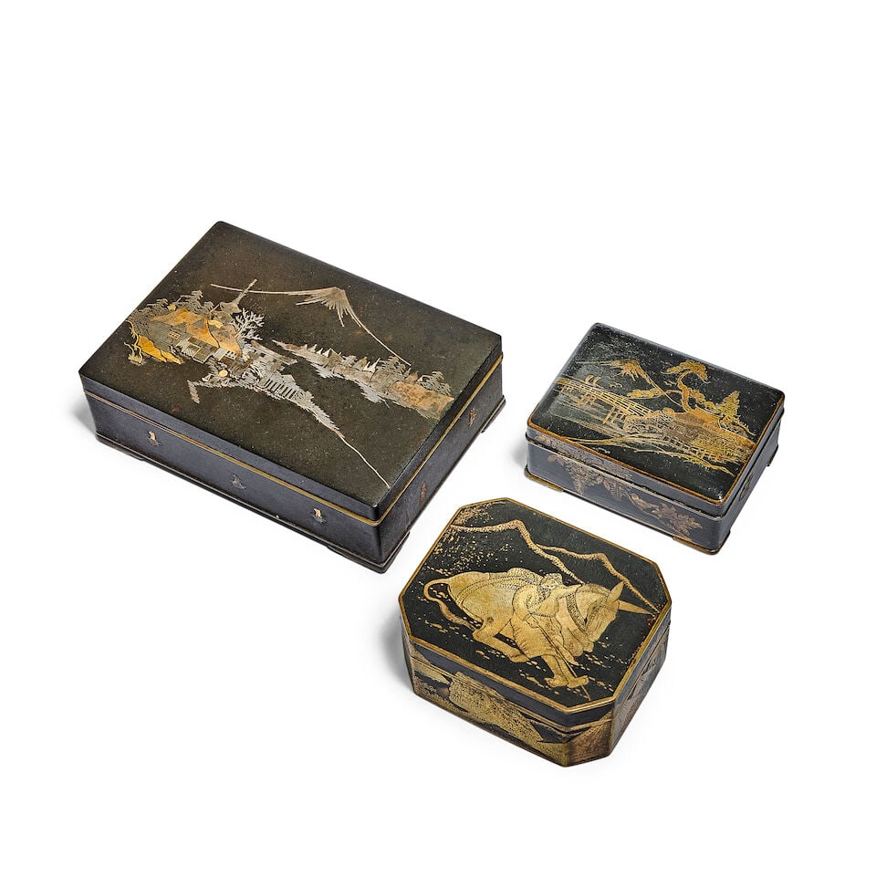 A collection of three Japanese gilt damascened iron small boxes made for the European market Lat...: A collection of three Japanese gilt damascened iron small boxes made for the European market Late Meiji period (1868-1912) or Taisho period (1912-1926) Comprising a canted box, the lid depicting a sle