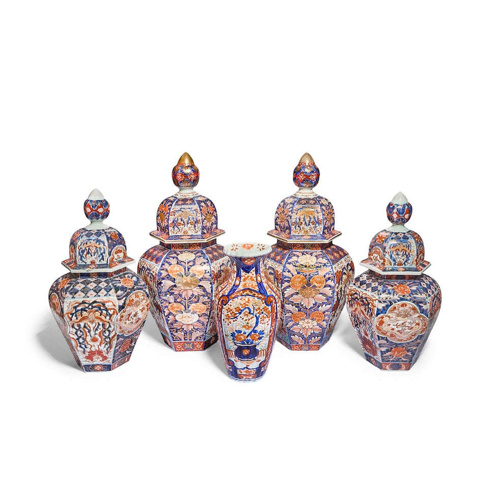 A matched Japanese Imari porcelain garniture of two pairs of graduated vases and covers together...: A matched Japanese Imari porcelain garniture of two pairs of graduated vases and covers together with an associated marched vase Late Meiji period (1868-1912) or Taisho period (1912-1926) The vases an