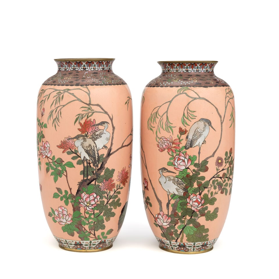 A pair of Japanese pink ground cloisonné vases Probably late Meiji (1680-1912) or Taish!...: A pair of Japanese pink ground cloisonné vases Probably late Meiji (1680-1912) or Taishō period (1912-1926), The slender inverted baluster bodies decorated with cranes and flowering peony an