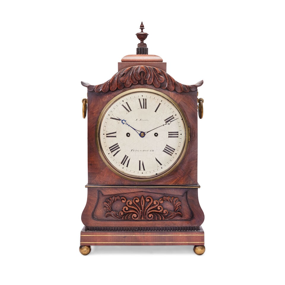 A mid 19th century mahogany striking bracket clock Signed J Jonas, Teignmouth: A mid 19th century mahogany striking bracket clock Signed J Jonas, Teignmouth The rectangular case with pagoda top with urn finial and carved decoration , the front with brass banding and an applied