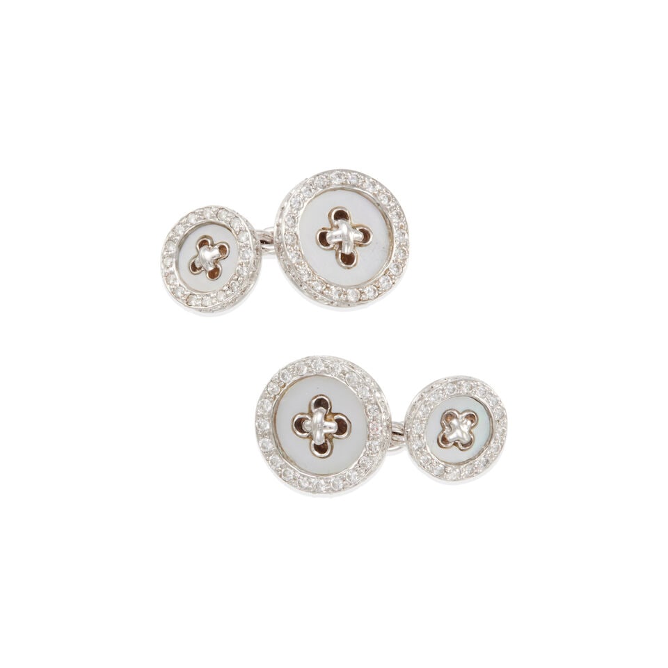 PAIR OF 18K WHITE GOLD, MOTHER OF PEARL, AND DIAMOND CUFFLINKS: PAIR OF 18K WHITE GOLD, MOTHER OF PEARL, AND DIAMOND CUFFLINKS • 18k white gold • 4 round tablet mother of pearl stones measuring from 7.90 mm to 10.10 mm each in diameter •