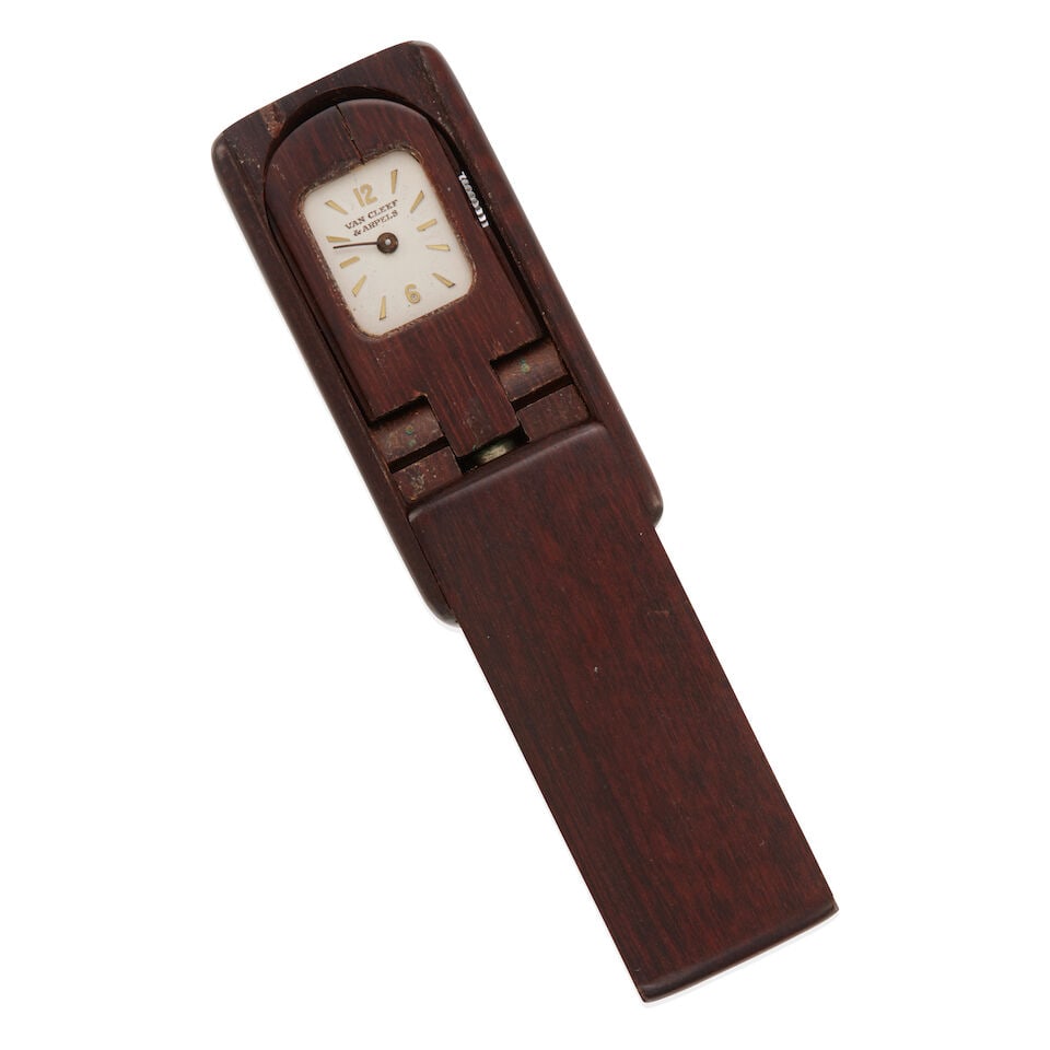 VAN CLEEF & ARPELS: TRAVEL WATCH: VAN CLEEF & ARPELS: TRAVEL WATCH • Wood case • Mechanical movement • Dail signed VAN CLEEF & ARPELS • Measures 1 7/8 x 15/16 x 3/8 in. • Estimated gross weight: 19.5