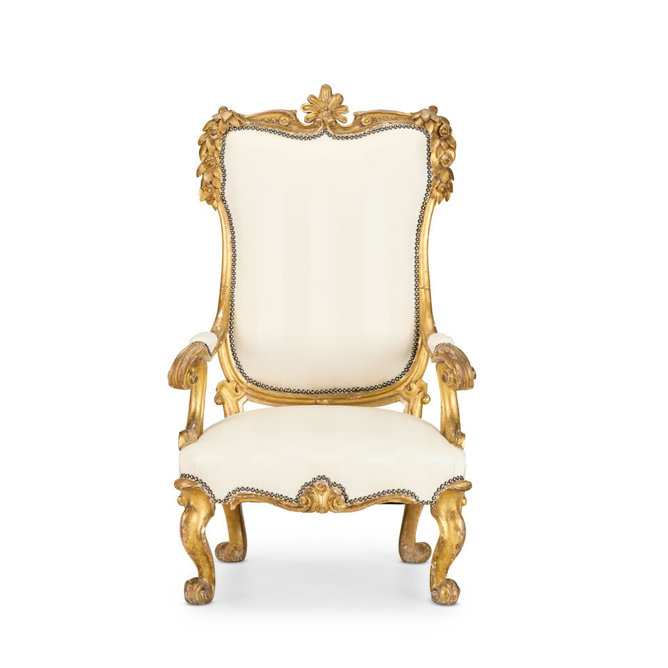 A Central Italian carved giltwood fauteuilSecond half 18th century: A Central Italian carved giltwood fauteuil Second half 18th century The upholstered back and seat and scrolled arms on cabriole legs and scrolled feet, 75cm wide x 67cm deep x 126cm high, (29.5in wide