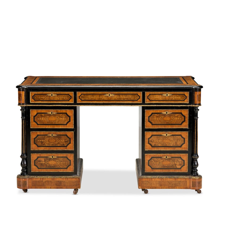 A Victorian walnut, tulipwood, ebonised and gilt metal mounted pedestal deskThird quarter 19th c...: A Victorian walnut, tulipwood, ebonised and gilt metal mounted pedestal desk Third quarter 19th century, in the French taste The kneehole enclosed by nine drawers and flanked by fluted and turned flar
