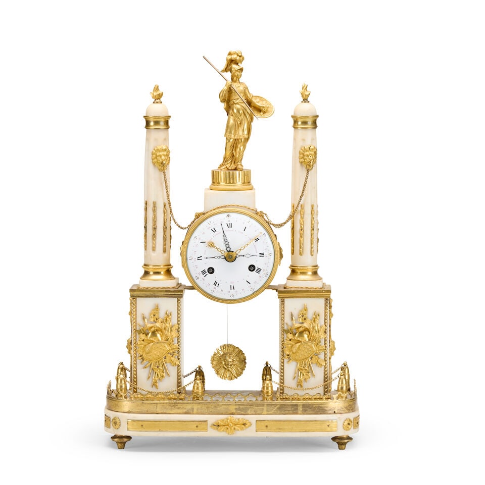 A large French early 19th century gilt bronze and marble mantel clock: A large French early 19th century gilt bronze and marble mantel clock The case surmounted by a figure of Diana holding a shield and spear supported by a pair of white marble columns with ormolu mounts