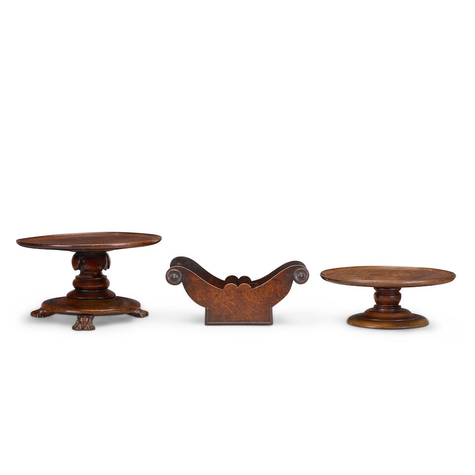 A George III oak and elm cheese coaster, together with two mahogany 'Lazy Susans' Late 18th cent...: A George III oak and elm cheese coaster, together with two mahogany 'Lazy Susans' Late 18th century and later The cheese coaster of typical boat form with scrolled ends, the 'Lazy Susan' with a rotati