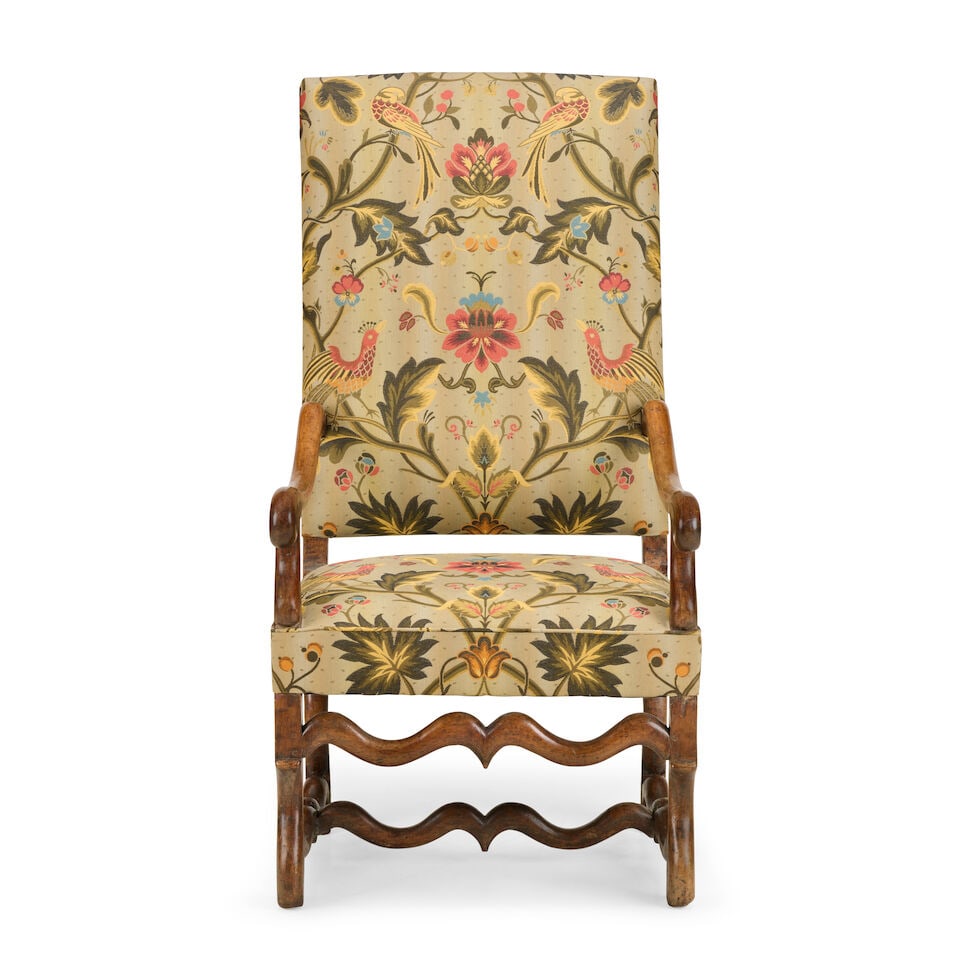 A French walnut 'Os de Mouton' fauteuilLate 17th century: A French walnut 'Os de Mouton' fauteuil Late 17th century Recently upholstered in floral silk damask, with scrolled arms and characteristic Os de Mouton (mutton bone) legs, 62cm wide x 81cm deep x 120