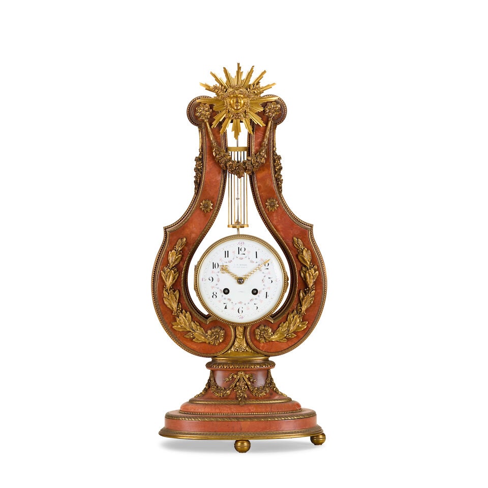 A French gilt-bronze mounted striking lyre clock Late 19th / early 20th century retailed by J.W....: A French gilt-bronze mounted striking lyre clock Late 19th / early 20th century retailed by J.W. Benson The red marble case mounted by a sunburst mount supported by a lyre shaped red marble body with
