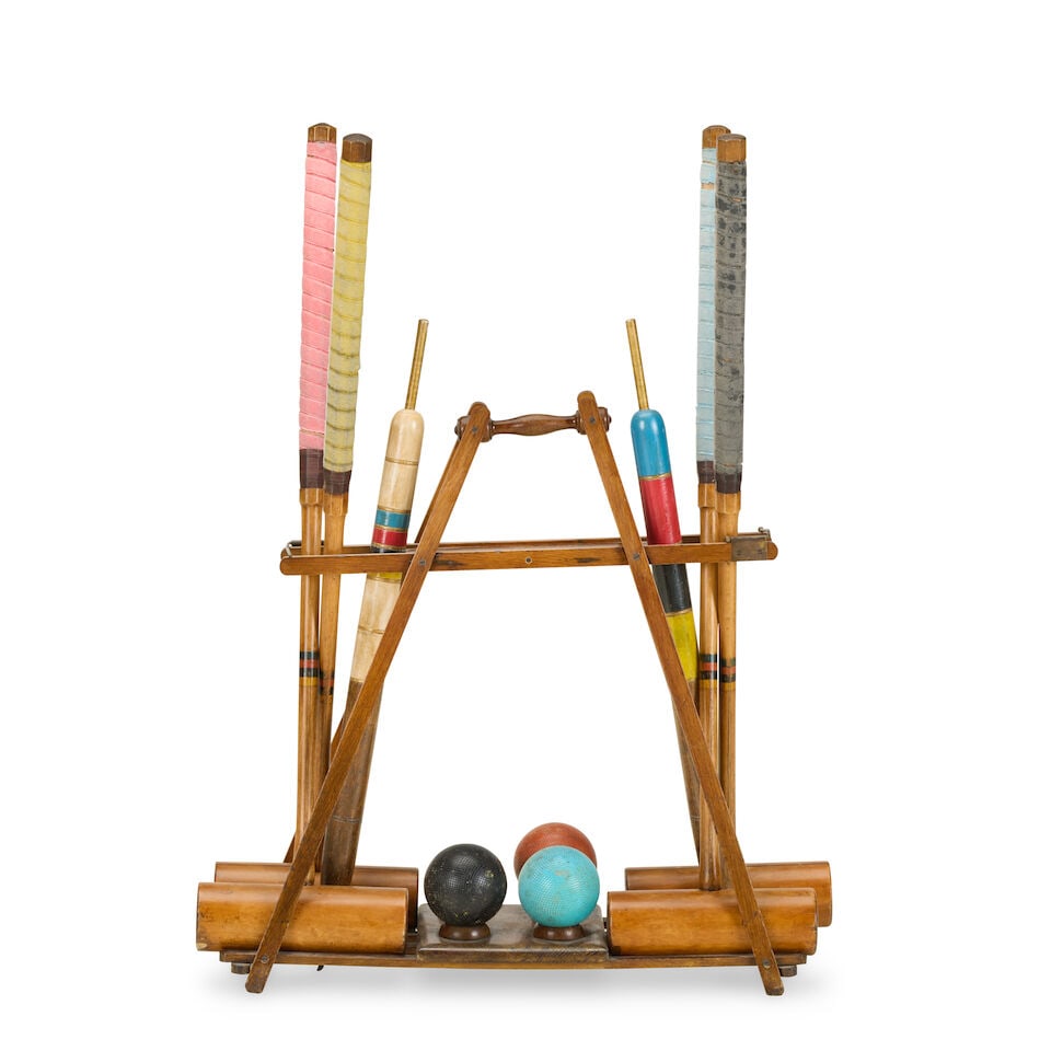'The Usborne': an early 20th century oak patent croquet 'Carrie' stand By F. H. Ayres: 'The Usborne': an early 20th century oak patent croquet 'Carrie' stand By F. H. Ayres With associated mallets, three balls and two coloured pegs, the stand: 64cm wide, 24cm deep, 65.5cm high (25in wid