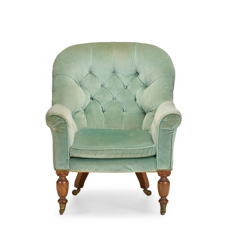 An early Victorian mahogany framed bergèreMid-19th century: An early Victorian mahogany framed bergère Mid-19th century Upholstered in green velvet on turned front legs, brass caps and castors, 71cm wide x 72cm deep x 89cm high, (27.5in wide x 28in deep x