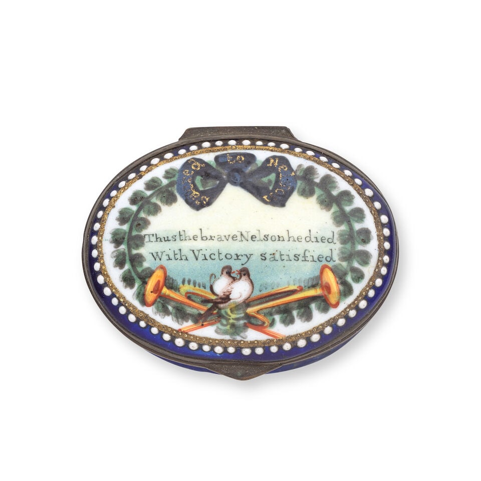 A South Staffordshire enamel patch box, early 19th century: A South Staffordshire enamel patch box, early 19th century Painted with a laurel wreath tied with a black mourning bow inscribed in gold 'Sacred to Nelson', a pair of doves resting on Fame's trumpets