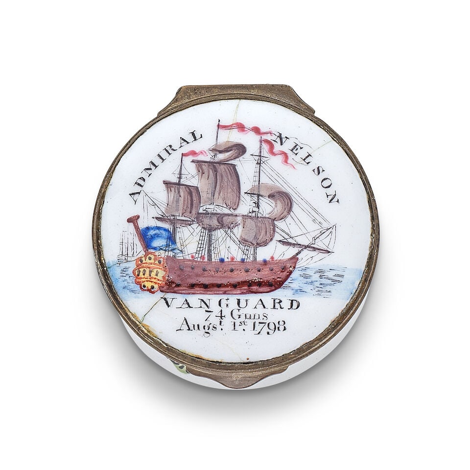 HMS Vanguard: A South Staffordshire enamel patch box, circa 1800: HMS Vanguard: A South Staffordshire enamel patch box, circa 1800 Of circular form, the lid printed and hand-coloured with 'VANGUARD, 74 Guns, Augst. 1st. 1798', the flagship in full sail, 'ADMIRAL NEL