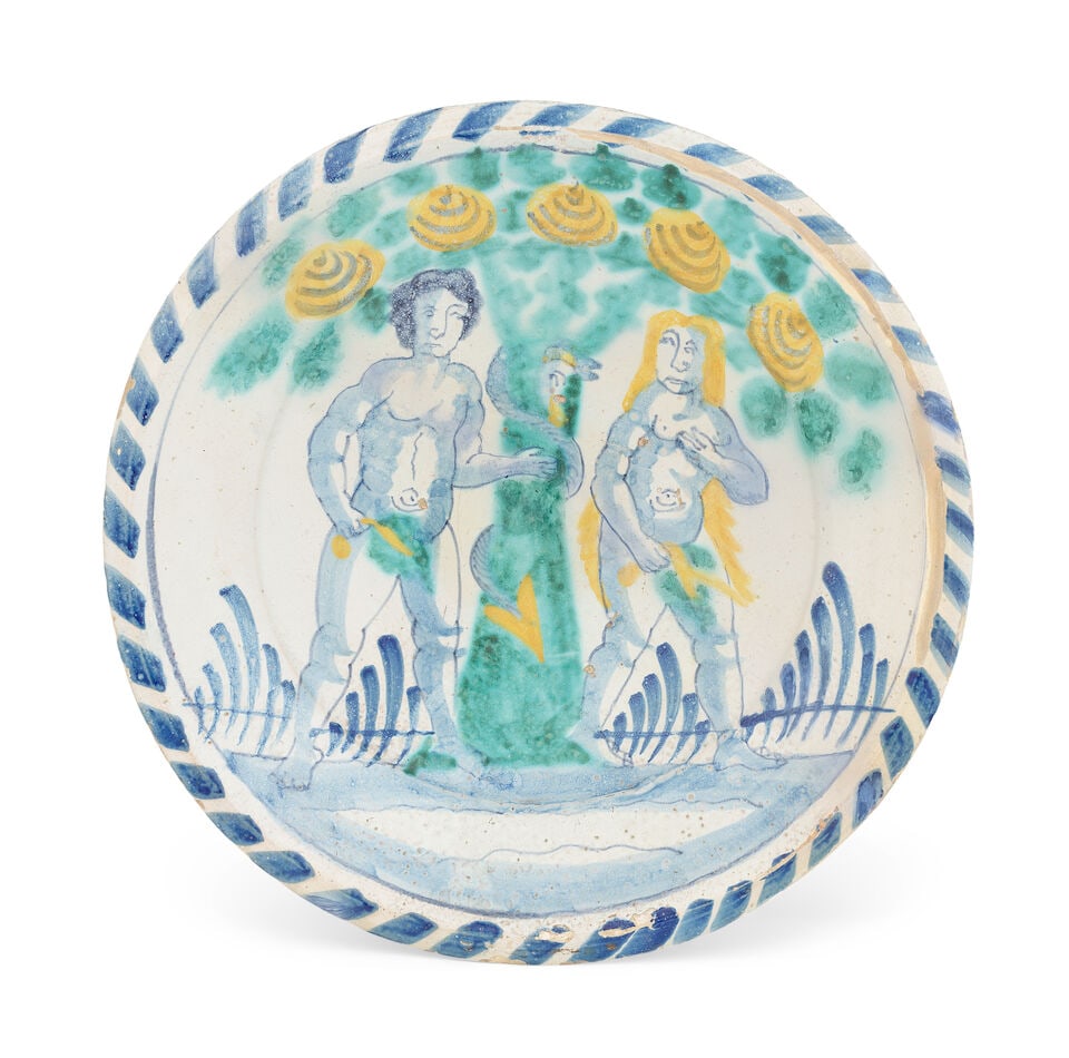 An English delftware Adam and Eve charger, circa 1680-90: An English delftware Adam and Eve charger, circa 1680-90 Probably Brislington, painted in tones of blue, turquoise green and yellow, Adam and Eve flanking the fruiting tree, the devilish snake coiled