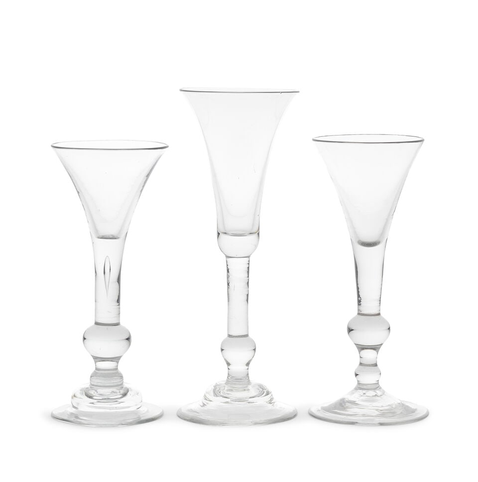 Two good baluster wine glasses and an ale glass, circa 1730-40: Two good baluster wine glasses and an ale glass, circa 1730-40 The stems with plain sections above terminating in solid baluster knops, the wines with drawn trumpet bowls, one with a domed foot, 17.3c