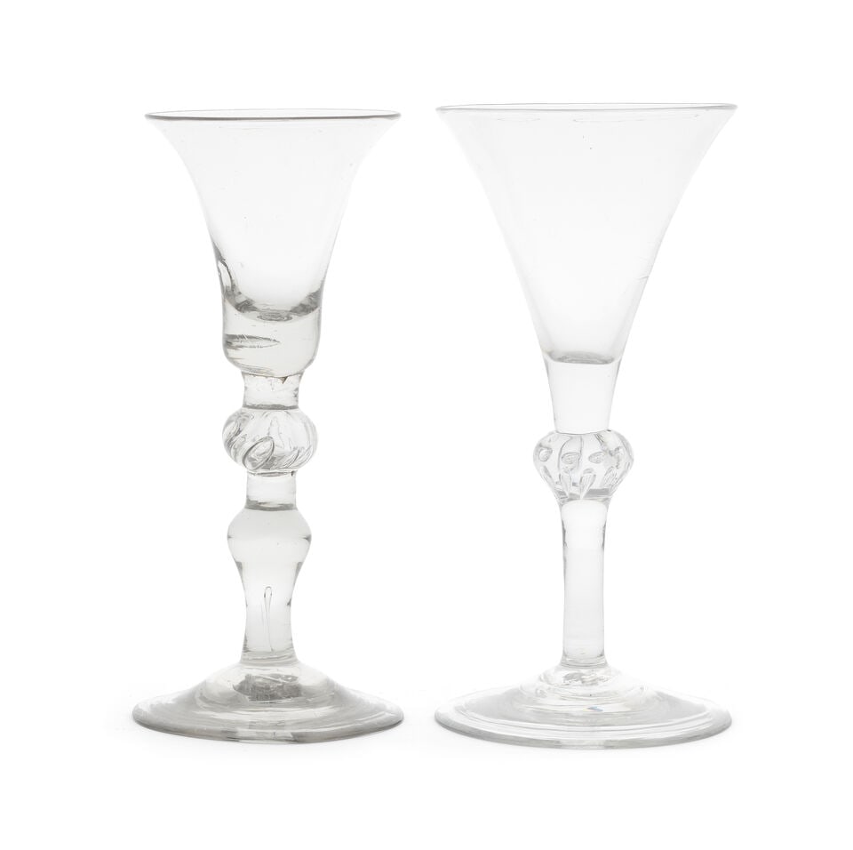Two composite stem baluster wine glasses, circa 1740: Two composite stem baluster wine glasses, circa 1740 One with a bell bowl with a solid base, the stem with a beaded shoulder knop set between short plain sections, above an inverted baluster, over a l