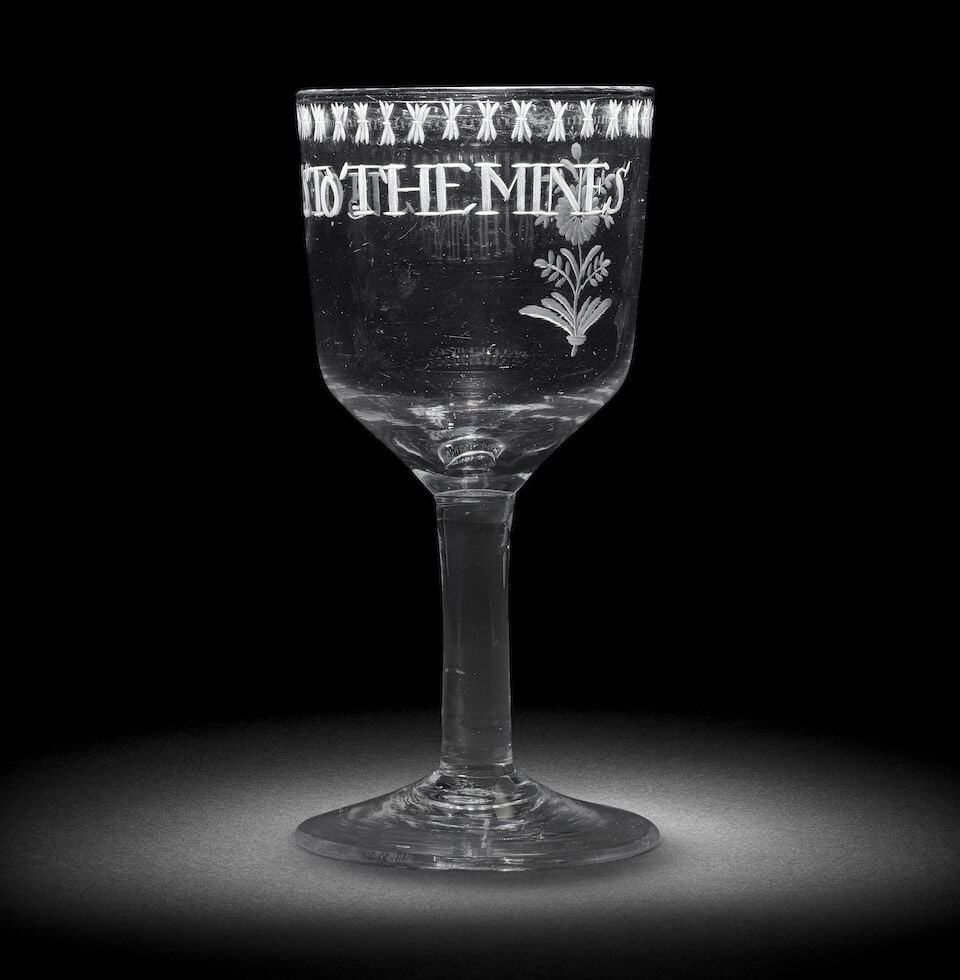 An engraved plain stem goblet, second half 18th century: An engraved plain stem goblet, second half 18th century The generous ogee bowl inscribed 'SUCCESS TO THE MINES', a stylised flower to the reverse, all below an 'OXO' border, on a plain stem and conica