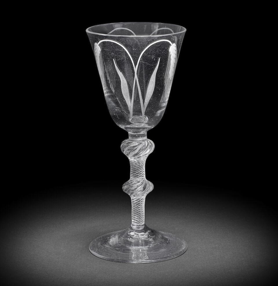 An engraved airtwist ale goblet, circa 1750: An engraved airtwist ale goblet, circa 1750 The generous round funnel bowl decorated on both sides with pairs of crossed barley ears, on a double-knopped multi-spiral airtwist stem and conical foot, 2