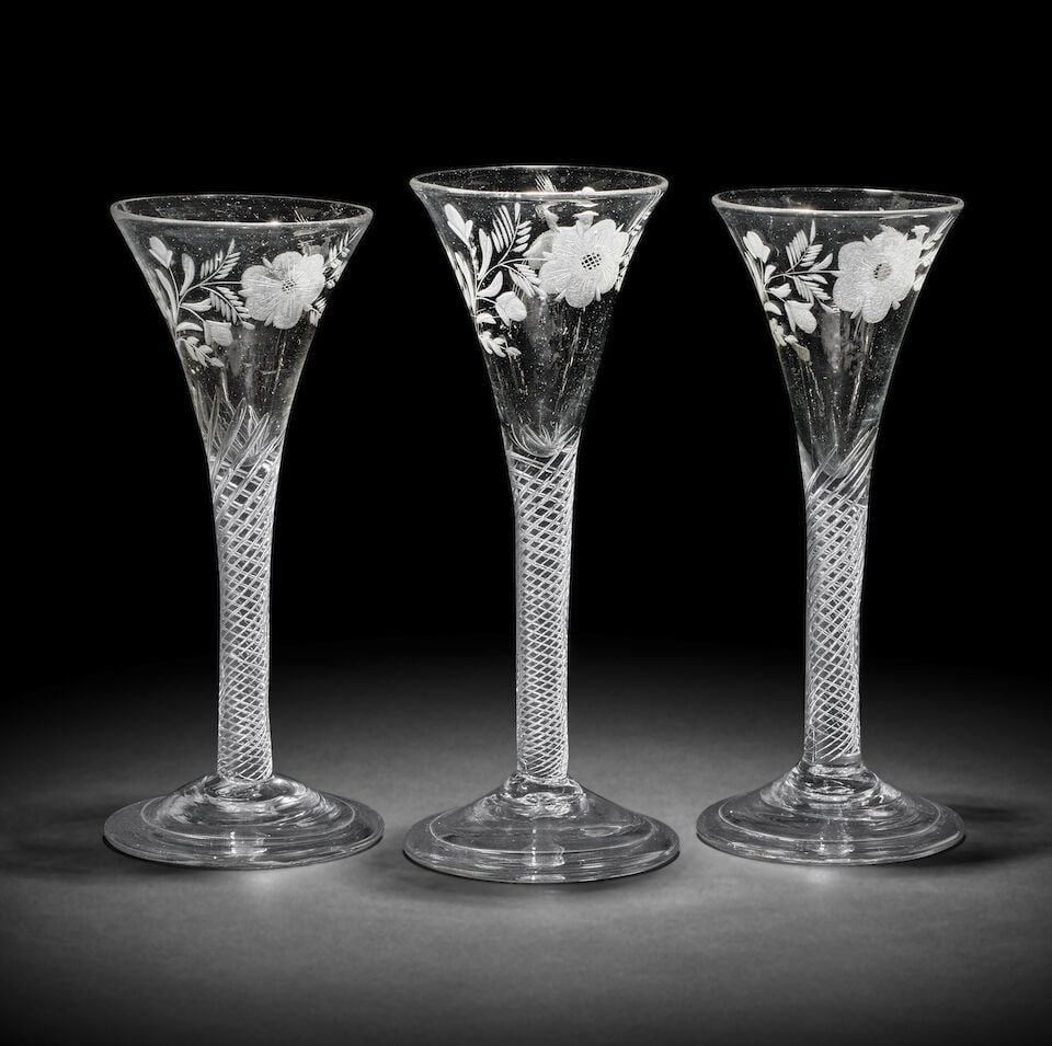 A set of three engraved airtwist wine glasses of possible Jacobite significance, circa 1750: A set of three engraved airtwist wine glasses of possible Jacobite significance, circa 1750 Each drawn trumpet bowl with a leafy stylised rose spray and a bird in flight to the reverse, set on multi-s