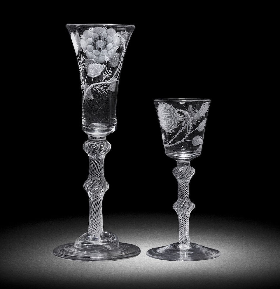An unusual engraved airtwist flute and a wine glass of possible Jacobite significance, circa 1750: An unusual engraved airtwist flute and a wine glass of possible Jacobite significance, circa 1750 With double-knopped multi-spiral airtwist stems, the flute with a tall waisted bucket bowl, decorated