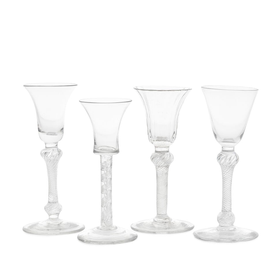 Four attractive airtwist wine glasses, circa 1750: Four attractive airtwist wine glasses, circa 1750 Three with multi-spiral airtwist stems, including one with a finely rib-moulded bell below on a shoulder-knopped stem; the others on stems with should
