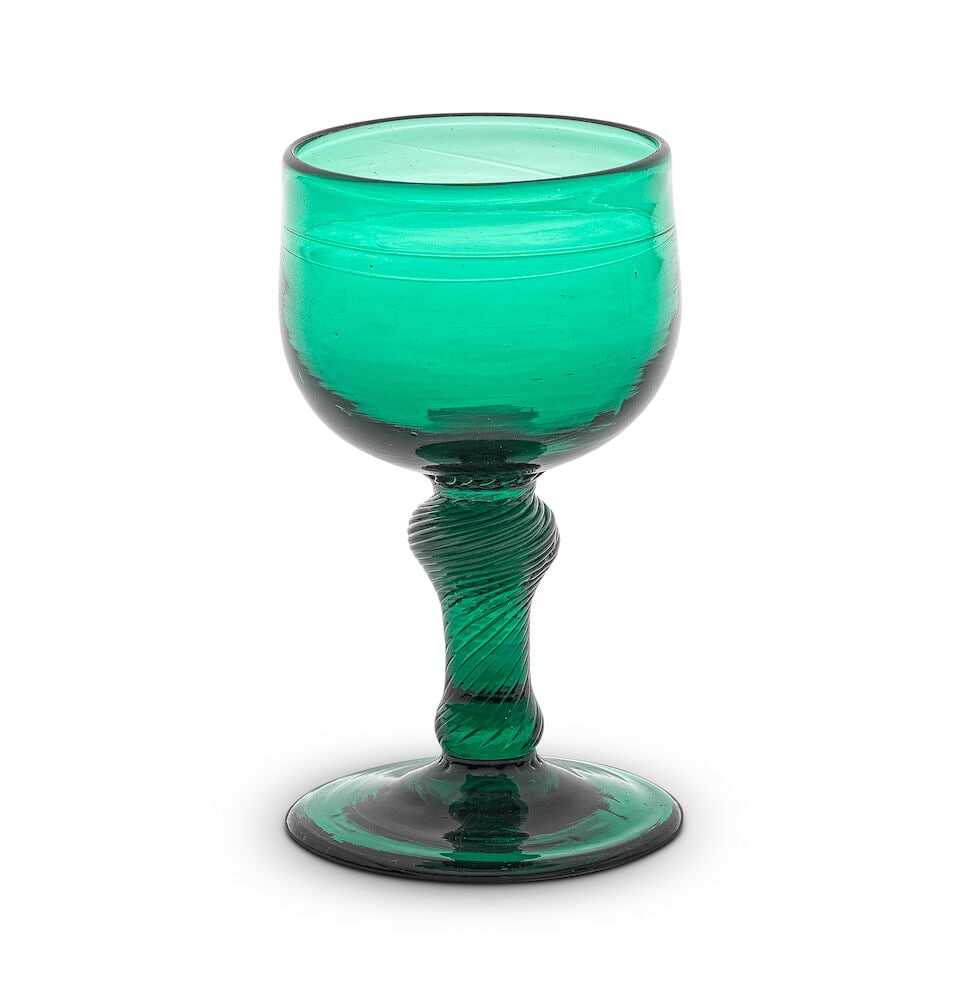 An emerald-green tinted incised twist wine or champagne glass, circa 1760: An emerald-green tinted incised twist wine or champagne glass, circa 1760 In deep green glass and of attractive small size, the cup-shaped bowl set on an inverted baluster incised twist stem with a ba