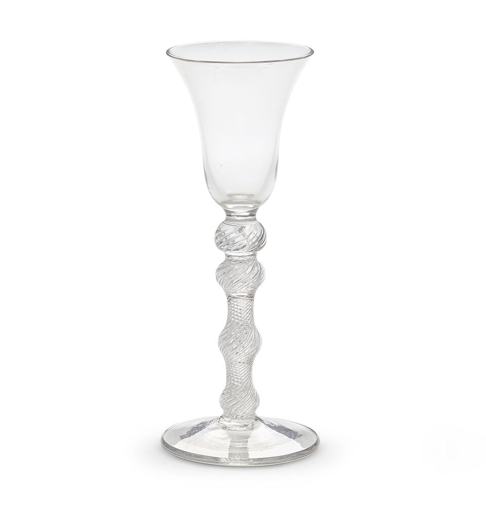 A rare four-knopped airtwist wine glass, circa 1750: A rare four-knopped airtwist wine glass, circa 1750 The bell bowl on a multi-spiral airtwist stem with two upper knops above lower swelling knop and basal knop, over a conical foot, 17.9cm high Footno