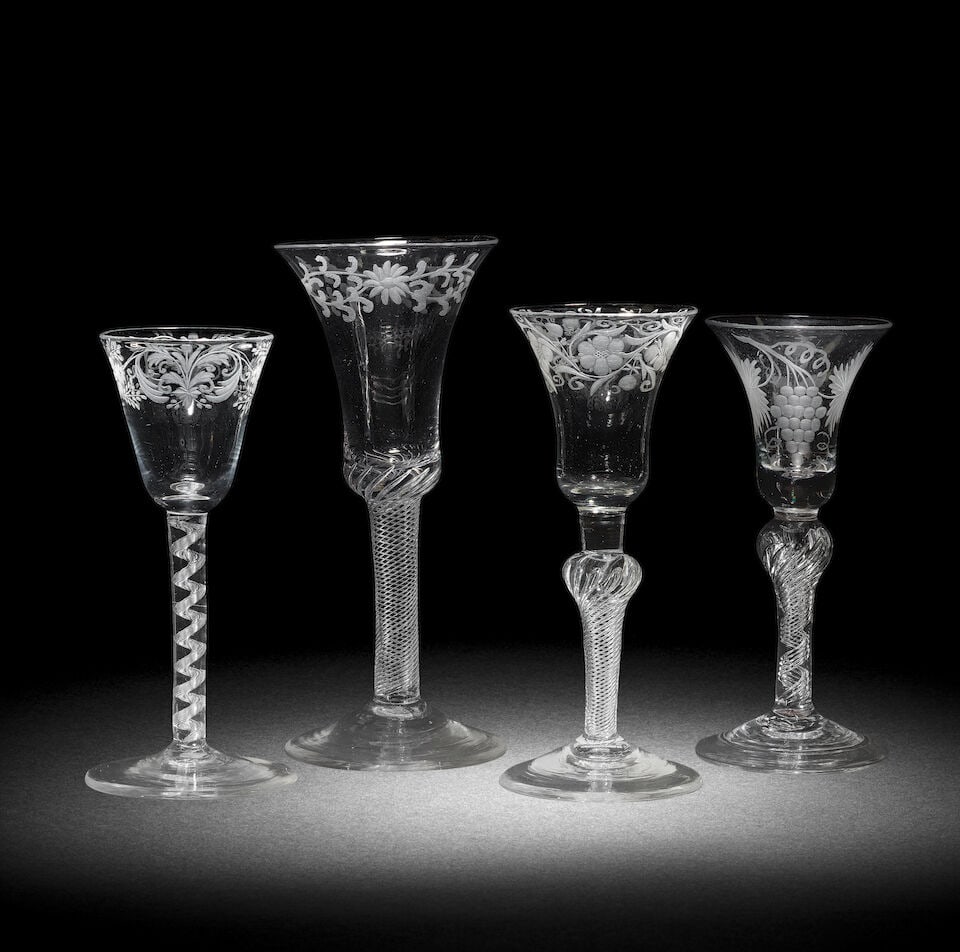 Three attractive engraved airtwist wine glasses and a composite stem glass, circa 1750: Three attractive engraved airtwist wine glasses and a composite stem glass, circa 1750 One with a round funnel bowl decorated with floral scrollwork, the stem with a spiral air cable, over a conical f