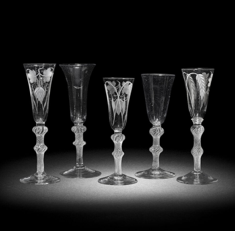 Five airtwist ale glasses, circa 1750: Five airtwist ale glasses, circa 1750 With double-knopped multi-spiral airtwist stems, three with tall and slightly flared round funnel bowls engraved with hops and barley; one with a tall bell bowl;