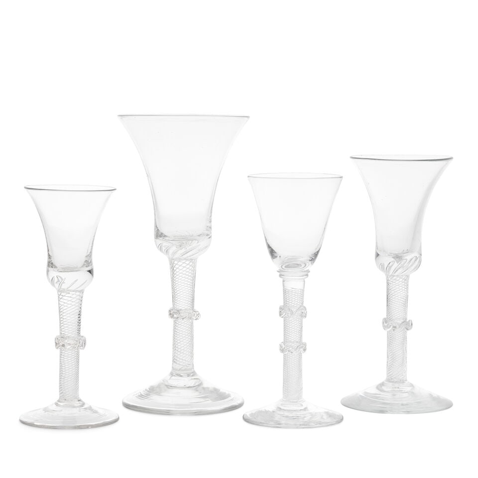 A good airtwist goblet and three wine glasses, circa 1750: A good airtwist goblet and three wine glasses, circa 1750 With multi-spiral airtwist stems, the goblet and two of the wine glasses with waisted bell bowls, the air threads extending into their solid b